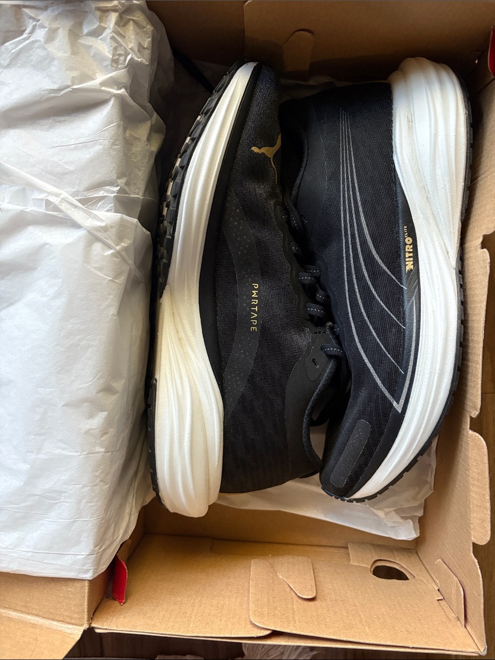 Puma Women’s Black Running Shoes with White Midsole and Gold Accents